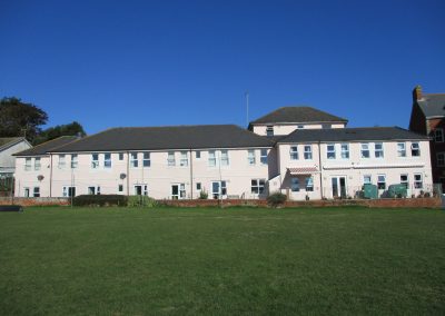 Large residential building next to grass area