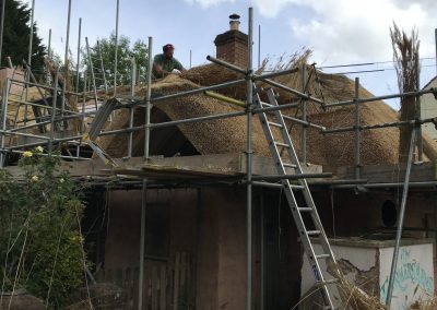 Man working on roof of historic building