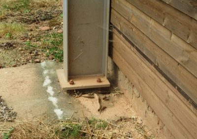Metal structure built next to wooden building